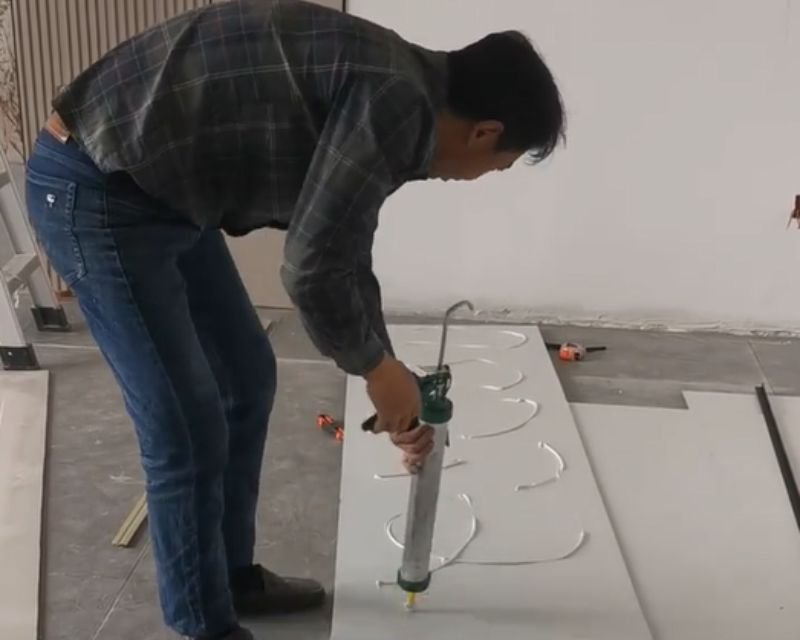 Carbon Crystal Wall Panel installation Step 2 applying adhesive or click system for WPC interior wall panel installation